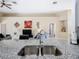 Kitchen featuring granite countertops, stainless steel sink and faucet, and an open view to the living area at 116 Westport Ln, Davenport, FL 33896