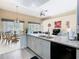 Modern kitchen with granite countertops, stainless steel appliances, and an open layout to the dining area at 116 Westport Ln, Davenport, FL 33896