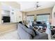 Open-concept living room showcases a ceiling fan, comfortable seating, and seamless transition to the dining area at 116 Westport Ln, Davenport, FL 33896