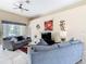 Comfortable living room featuring neutral walls, contemporary decor, and sliding door access to the lanai at 116 Westport Ln, Davenport, FL 33896