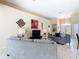 Open concept living room with neutral color palette and decorative wall art at 116 Westport Ln, Davenport, FL 33896