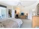 Bright main bedroom with ceiling fan, view of the desk area, and ensuite bathroom access at 116 Westport Ln, Davenport, FL 33896