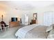 Spacious main bedroom featuring a ceiling fan, dresser, and ensuite bathroom access at 116 Westport Ln, Davenport, FL 33896