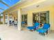 Inviting patio with a view of outdoor seating and a screened-in pool and spa, perfect for entertaining at 116 Westport Ln, Davenport, FL 33896