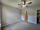 A cozy bedroom with gray carpet and a ceiling fan providing a relaxing atmosphere at 1325 Lake Shadow Cir # 12205, Maitland, FL 32751