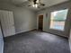 Bedroom with neutral carpet, showing closet and a large window at 1325 Lake Shadow Cir # 12205, Maitland, FL 32751