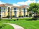 Exterior of apartment building with green space and a pond at 1325 Lake Shadow Cir # 12205, Maitland, FL 32751