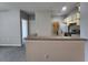 Kitchen with tiled floor, countertop bar, and view to the laundry area at 1325 Lake Shadow Cir # 12205, Maitland, FL 32751