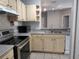 Kitchen features stainless steel range, dishwasher, tile backsplash, and view of living area at 1325 Lake Shadow Cir # 12205, Maitland, FL 32751