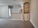 View of the open-concept living space including custom built in shelving and gray carpet at 1325 Lake Shadow Cir # 12205, Maitland, FL 32751