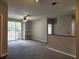 Open concept living room featuring carpet flooring, ceiling fan, a balcony, and a view of the kitchen at 1325 Lake Shadow Cir # 12205, Maitland, FL 32751
