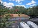 Scenic parking lot view, with covered spaces and flowering trees at 1325 Lake Shadow Cir # 12205, Maitland, FL 32751