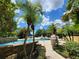 Community pool with palm trees and seating in a sunny setting at 1325 Lake Shadow Cir # 12205, Maitland, FL 32751