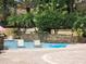 Community pool with in-water seating, stone wall, and palm trees at 1325 Lake Shadow Cir # 12205, Maitland, FL 32751