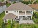 Aerial view of the large backyard with a patio, covered balcony, and lush landscaping at 16072 Shasta St, Clermont, FL 34714