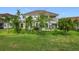 Well-maintained backyard featuring mature landscaping and a two story home at 16072 Shasta St, Clermont, FL 34714