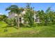 Lush backyard with mature trees and landscaping surrounding the house, providing plenty of privacy at 16072 Shasta St, Clermont, FL 34714