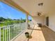 Large, covered balcony with a ceiling fan overlooking the lawn, offering plenty of room for outdoor enjoyment at 16072 Shasta St, Clermont, FL 34714