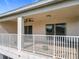Spacious, covered balcony with ceiling fans and white railings, creating a comfortable outdoor space at 16072 Shasta St, Clermont, FL 34714