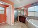 En-suite bathroom with glass-enclosed shower, garden tub, and double vanity at 16072 Shasta St, Clermont, FL 34714