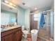 Bathroom featuring a glass enclosed shower, tile surround, and granite vanity at 16072 Shasta St, Clermont, FL 34714