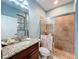 Modern bathroom with a glass-enclosed shower and granite-topped vanity at 16072 Shasta St, Clermont, FL 34714