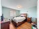 Spacious bedroom featuring wood floors and a modern light fixture at 16072 Shasta St, Clermont, FL 34714