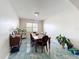 A dining room with dark wood furniture, chandelier, and blue marble-style flooring at 16072 Shasta St, Clermont, FL 34714