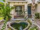 Charming front entrance with a heart-shaped pond, stone walkway, and inviting blue door at 16072 Shasta St, Clermont, FL 34714