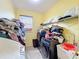 Laundry area with sink, folding counter, shelving, and stacked washer and dryer at 16072 Shasta St, Clermont, FL 34714