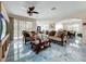 Spacious living room with couches, ceiling fan, open layout to dining area at 16072 Shasta St, Clermont, FL 34714