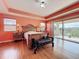 The main bedroom features a tray ceiling, access to a balcony, and two large windows for lots of natural light at 16072 Shasta St, Clermont, FL 34714