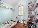 This room has a small desk, day bed, wire shelving and a window with natural light at 16072 Shasta St, Clermont, FL 34714