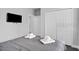 The bedroom is stylishly appointed with a tv, ensuite bath, and closet at 163 Kenny Blvd, Haines City, FL 33844