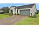 Inviting single-story home with a two-car garage, beautiful lawn and minimalist landscaping at 163 Kenny Blvd, Haines City, FL 33844