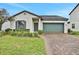 Charming single-Gathering home with a neat lawn, brick driveway and attached two-car garage at 163 Kenny Blvd, Haines City, FL 33844