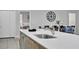 Modern kitchen features quartz counters and stainless steel appliances overlooking the dining area at 163 Kenny Blvd, Haines City, FL 33844
