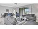 Cozy living room with neutral tones, comfortable seating, and view to the screened-in patio at 163 Kenny Blvd, Haines City, FL 33844
