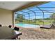 Private screened-in pool with comfortable lounge chairs and outdoor dining at 163 Kenny Blvd, Haines City, FL 33844