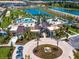 Aerial view of community amenities including the pool, community center, pond, and manicured landscaping at 1810 Caribbean View Ter, Kissimmee, FL 34747