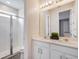 Bright bathroom with double vanity, glass shower, and ample counter space at 1810 Caribbean View Ter, Kissimmee, FL 34747
