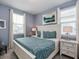Bedroom features plenty of natural light from the large window and a calm, cool color palette at 1810 Caribbean View Ter, Kissimmee, FL 34747
