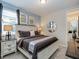 Comfortable bedroom features stylish decor, a decorative mirror, and an ensuite bathroom at 1810 Caribbean View Ter, Kissimmee, FL 34747