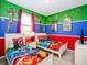 The bedroom is decorated with Marvel-themed decor, bright colored walls, and two twin beds at 1810 Caribbean View Ter, Kissimmee, FL 34747
