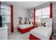 ' bedroom with two twin beds, playful decor, and bright red curtains at 1810 Caribbean View Ter, Kissimmee, FL 34747