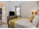 Cozy bedroom features a TV, modern decor, and a comfortable queen-sized bed at 1810 Caribbean View Ter, Kissimmee, FL 34747