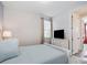 Serene bedroom with a comfortable bed, soft natural light, and a view into an adjacent room at 1810 Caribbean View Ter, Kissimmee, FL 34747
