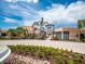 Community clubhouse showcasing manicured landscaping, creating an inviting atmosphere for residents at 1810 Caribbean View Ter, Kissimmee, FL 34747