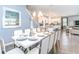 Chic dining area with seating for ten, open to the kitchen and living space, with stylish decor at 1810 Caribbean View Ter, Kissimmee, FL 34747