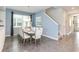 Bright dining room with a modern table setting, ample seating, and easy access to the staircase at 1810 Caribbean View Ter, Kissimmee, FL 34747